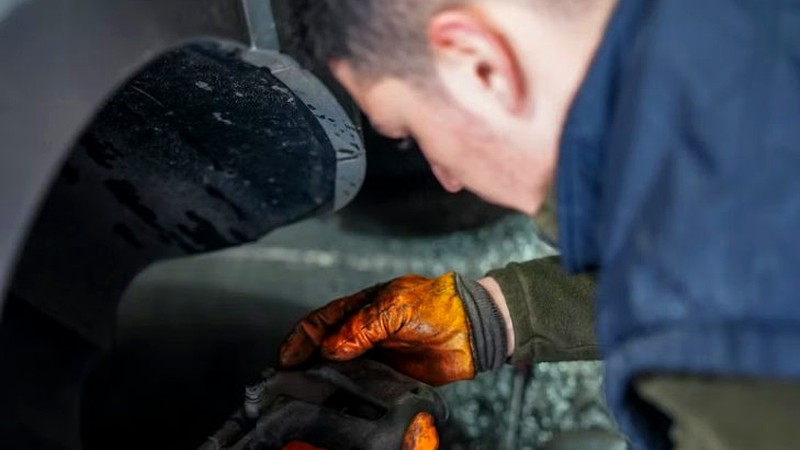 MGE California brake technician performing a brake inspection