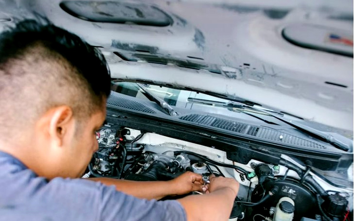 MGE California technician working on a car engine